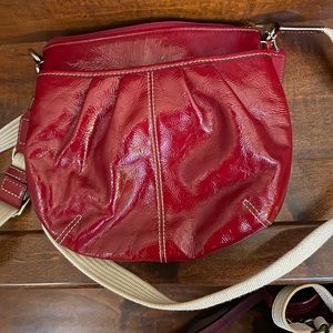 Red patent Coach crossbody purse.